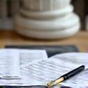 Tax paperwork alongside a marble statue